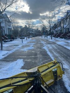 Snow management team clearing a road after a winter snow storm.