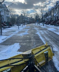 Snow management team clearing a road after a winter snow storm.