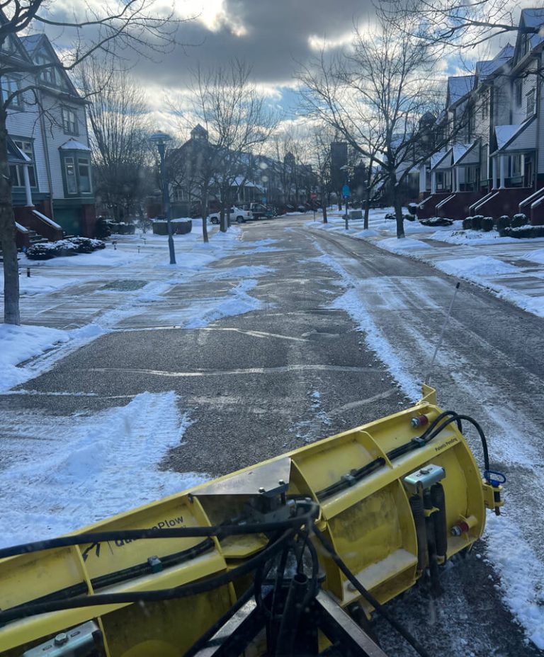 Snow management team clearing a road after a winter snow storm.